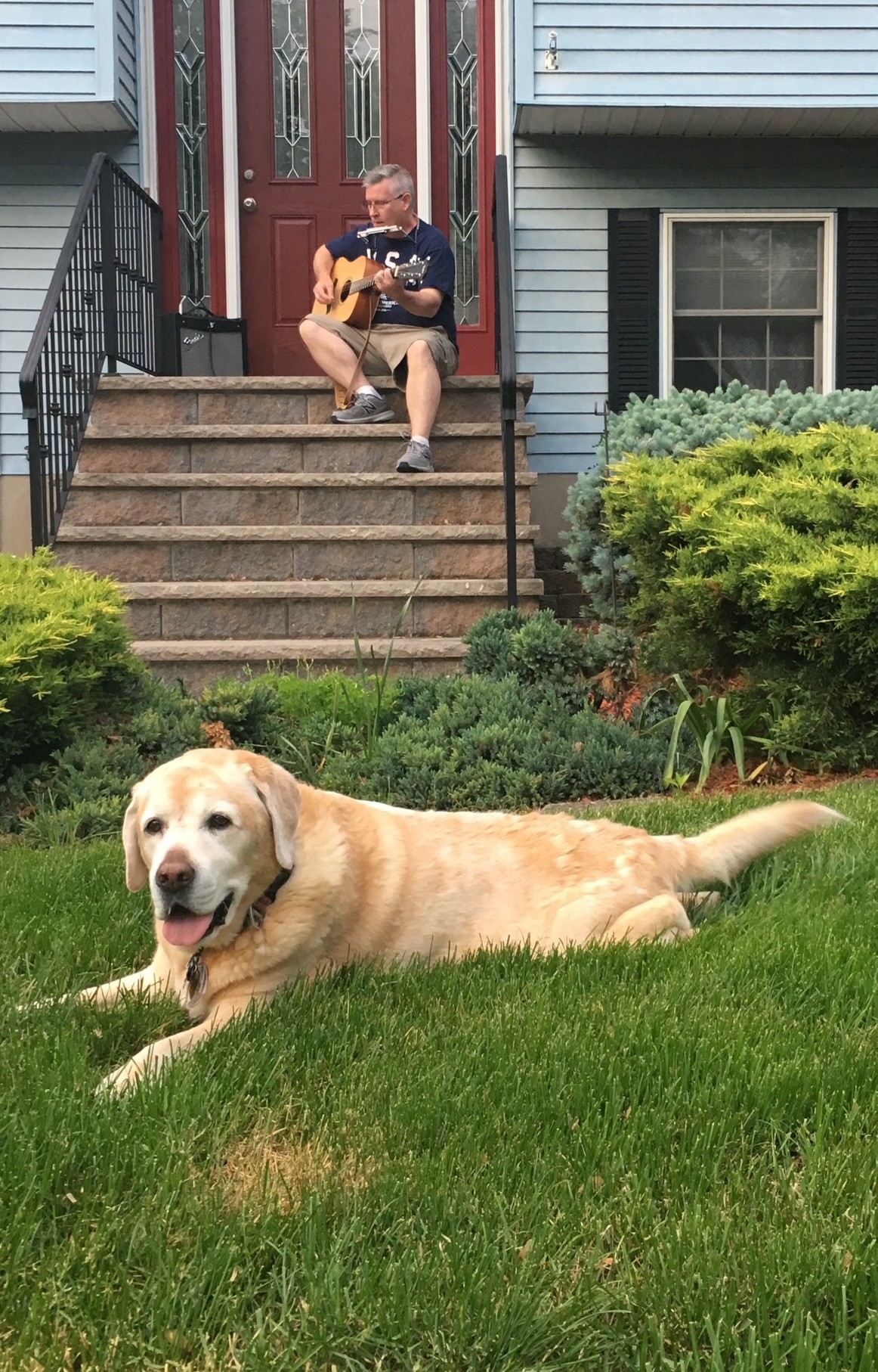 Butters relaxing while Steve plays guitar on the porch